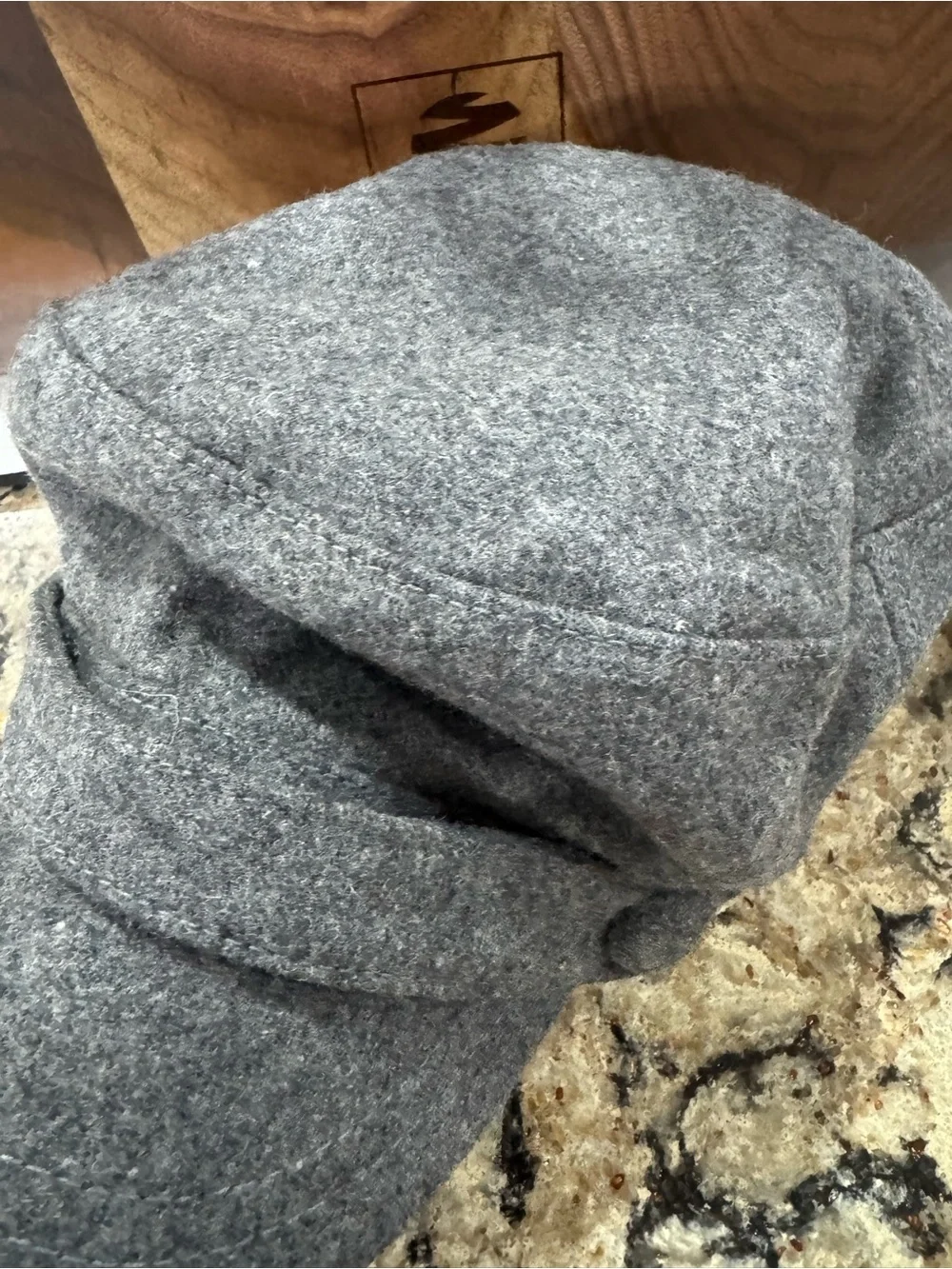 Gray newsboy cap features a felted wool blend material (CL-3)